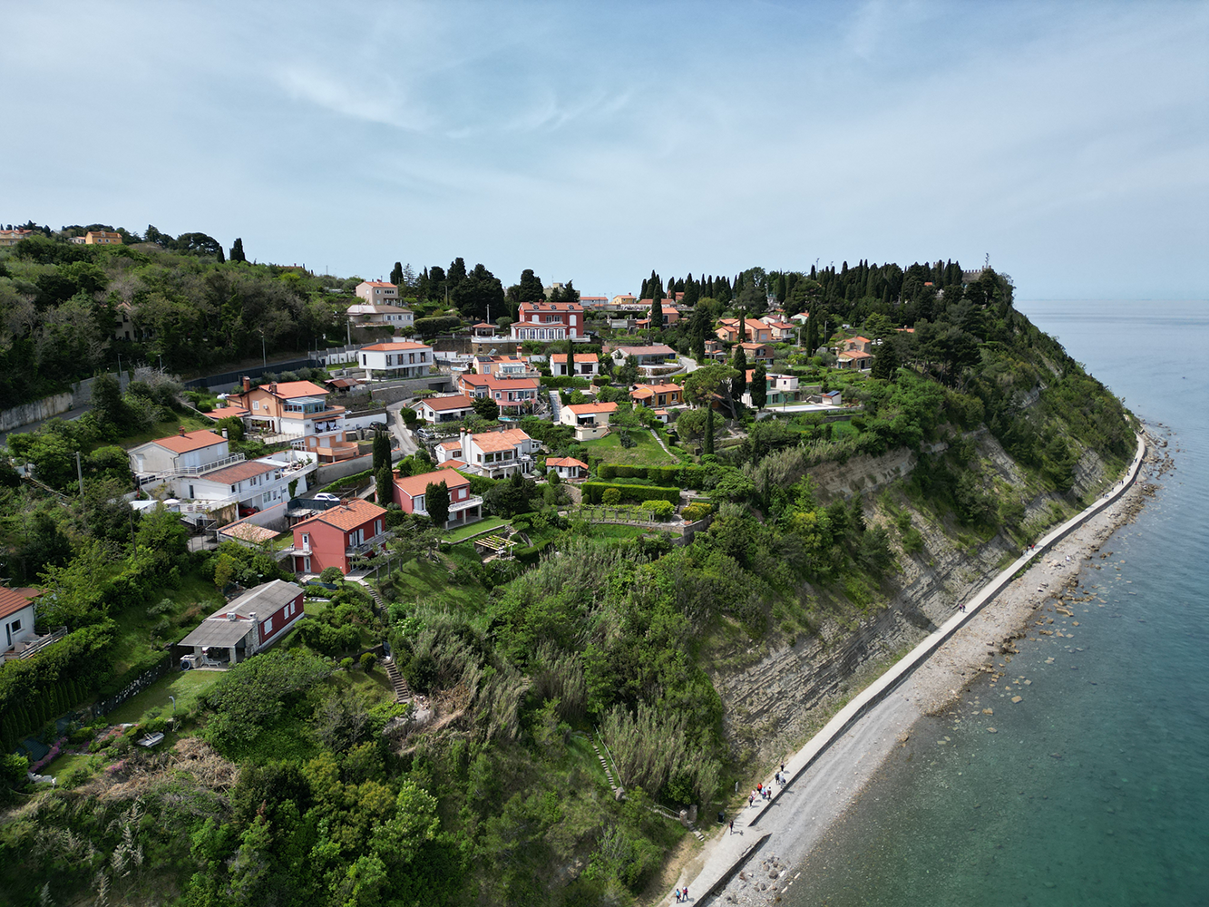 Panoramic view overlooking Piran Old Town from the Piran city walls, with its charming narrow streets, orange-tiled roofs, and the Adriatic Sea in the background.