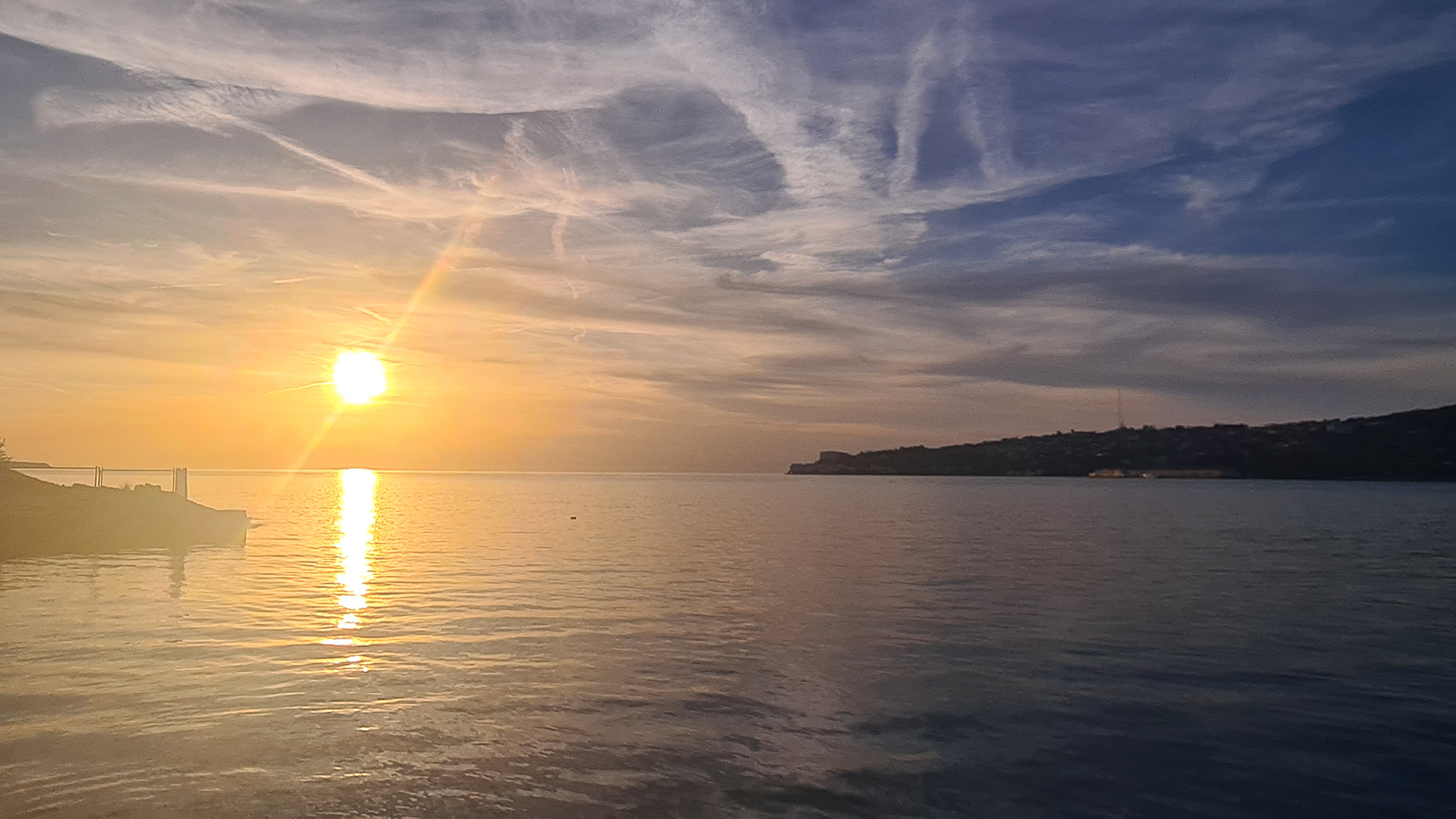 Evening sunset view from Camp Lucija overlooking the sea, with colorful hues painting the sky and reflecting on the tranquil waters.