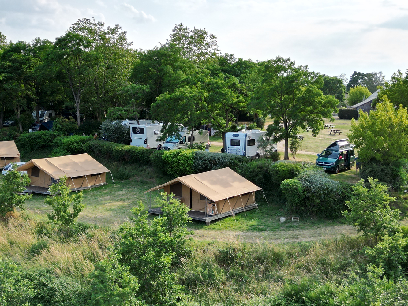 Aerial view of Camping Huttopia Saumur, a serene campground nestled in the beautiful countryside.