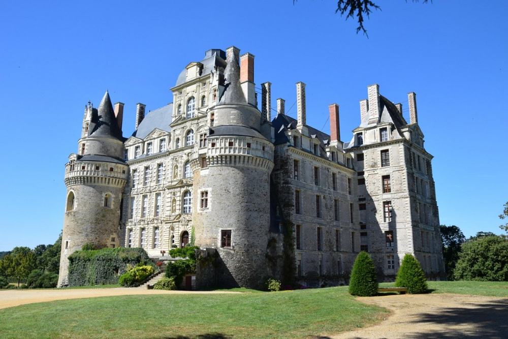 Front view of the majestic Château de Brissac, showcasing its impressive architecture and grandeur.