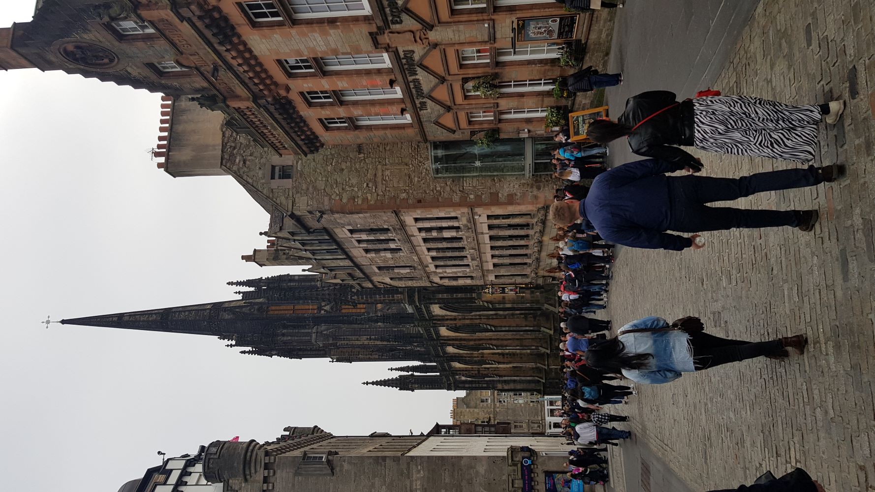 People walking around the historic streets of Edinburgh town.
