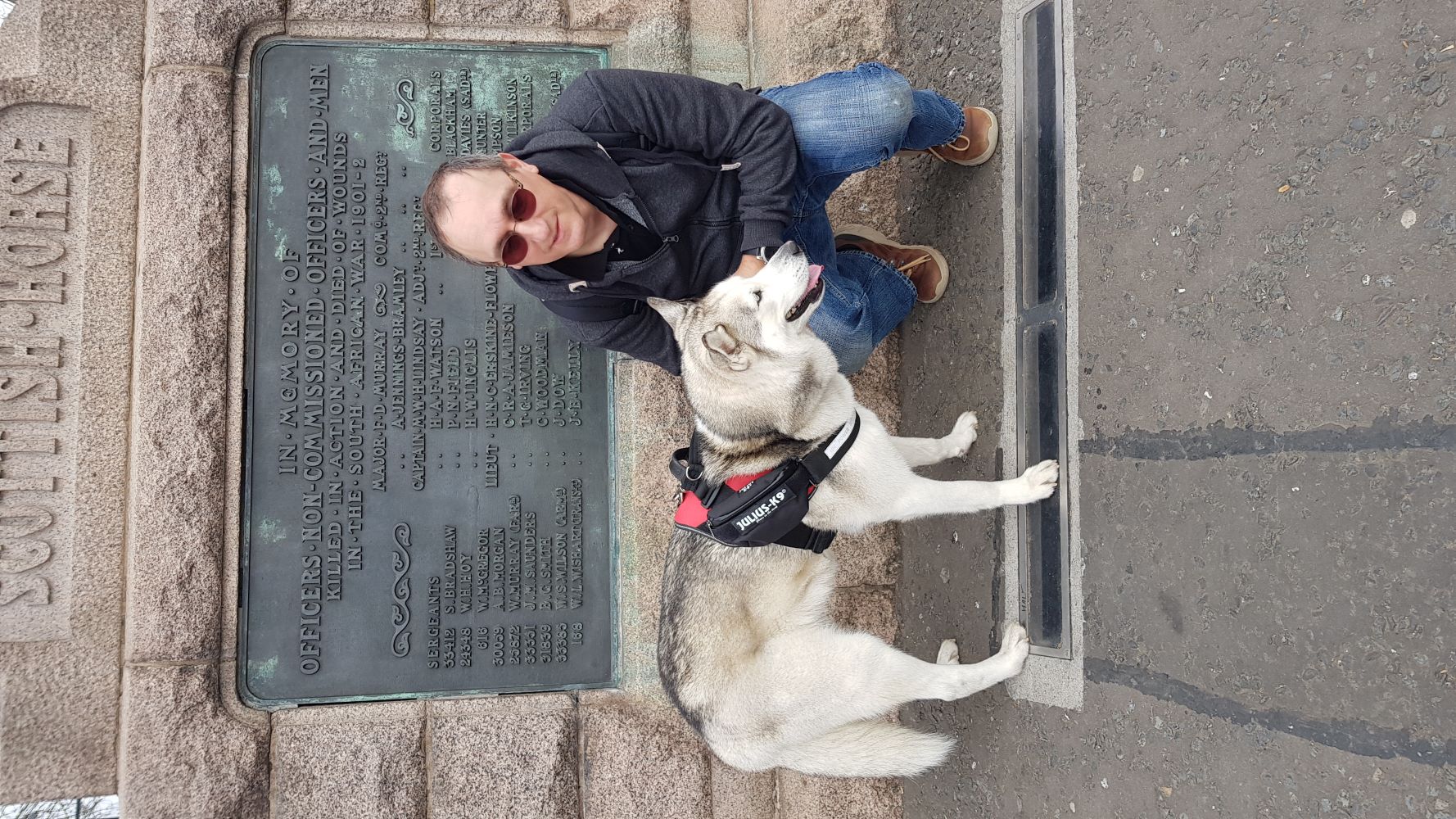 Selfie with a dog in front of the monument of Scottish horse riders in Edinburgh.