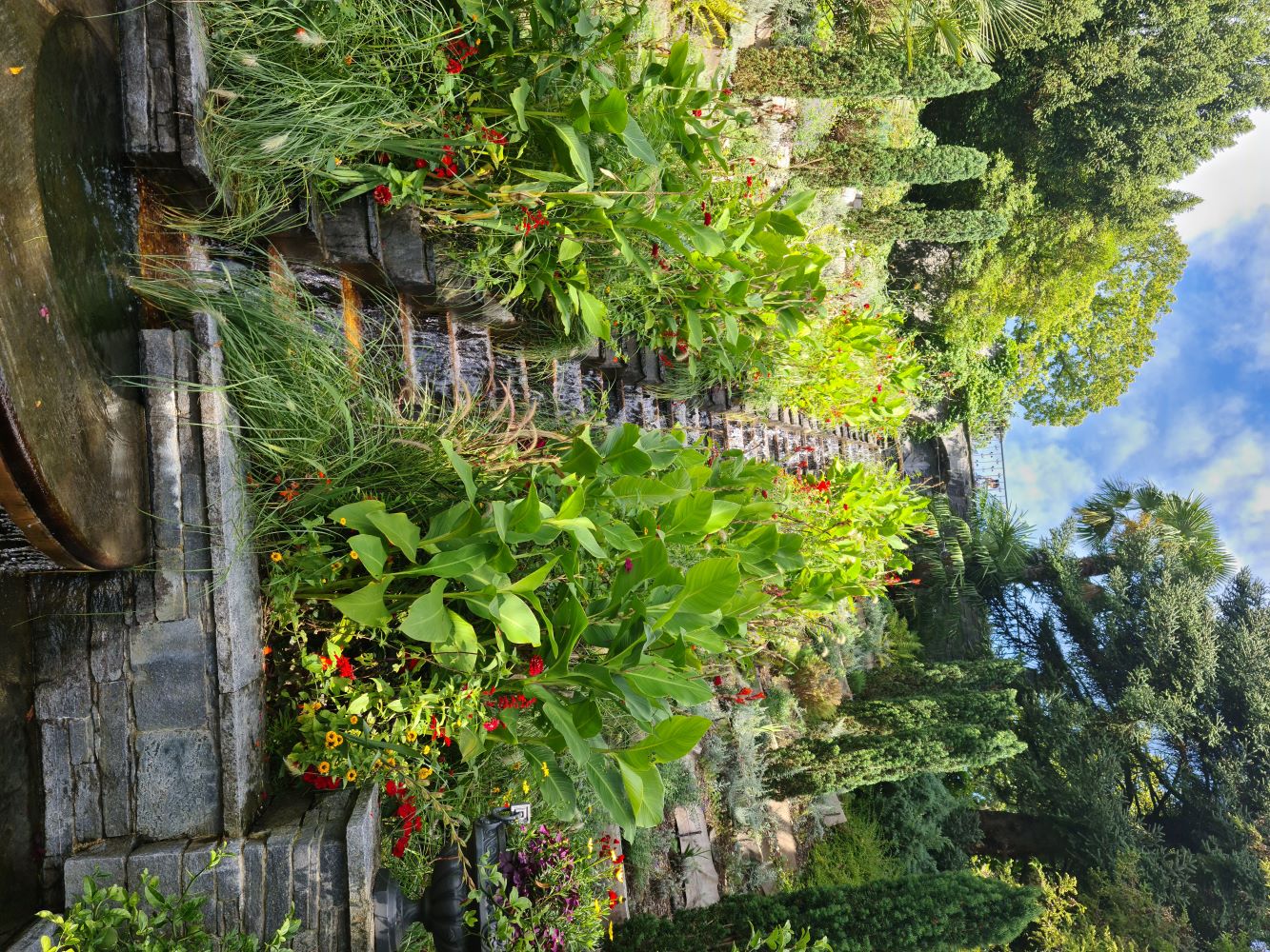 Garden stairs at Mainau Island leading up with lush greenery and colorful flowers on either side.