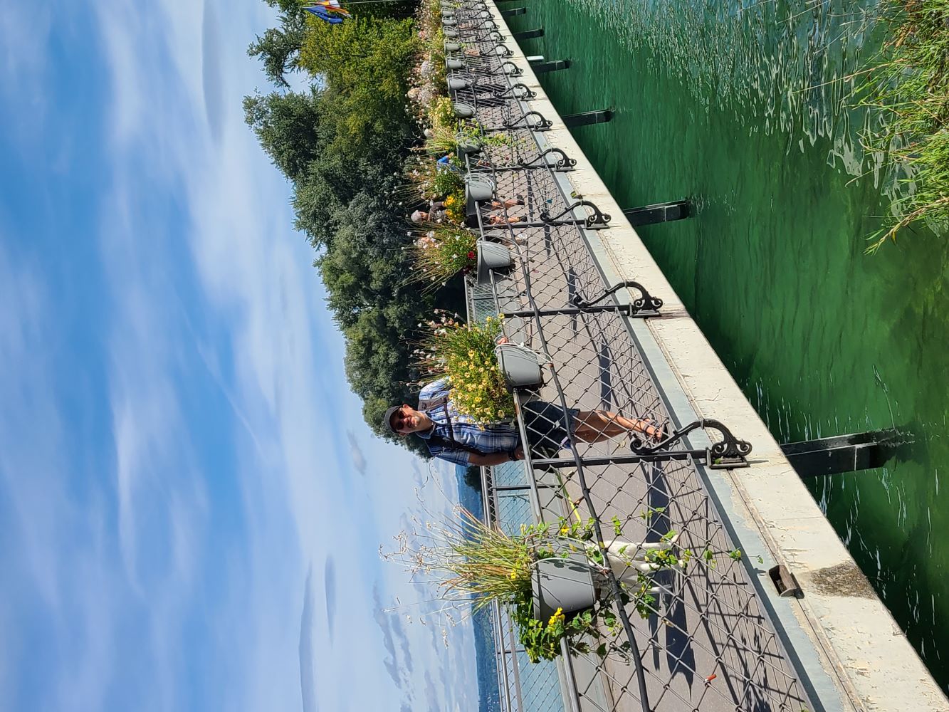 Bridge leading to Mainau Island, with the lush greenery and vibrant gardens visible in the distance.