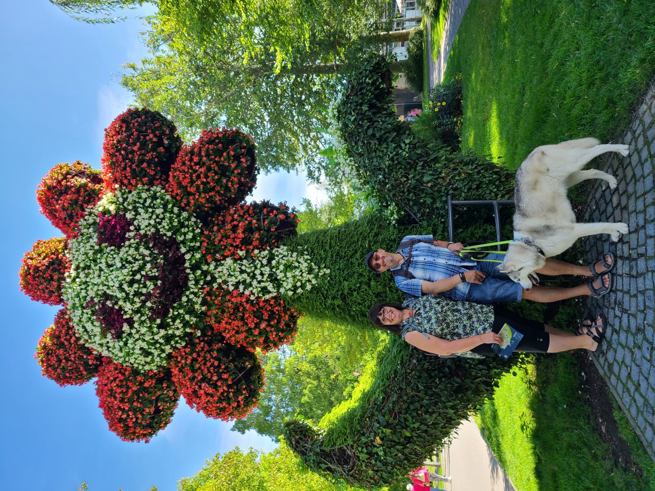 Giant flower sculpture on Mainau Island, surrounded by colorful blooms and lush greenery.
