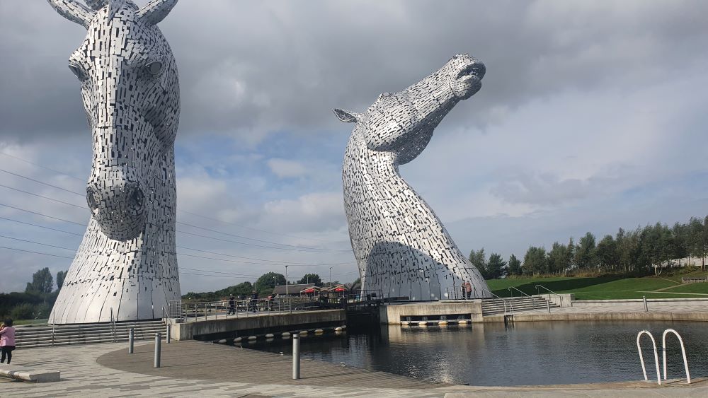 he Kelpies sculptures during the day under a clear blue sky.