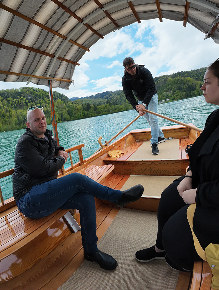Pletna boats on Lake Bled, with traditional wooden design and the serene lake in the background.