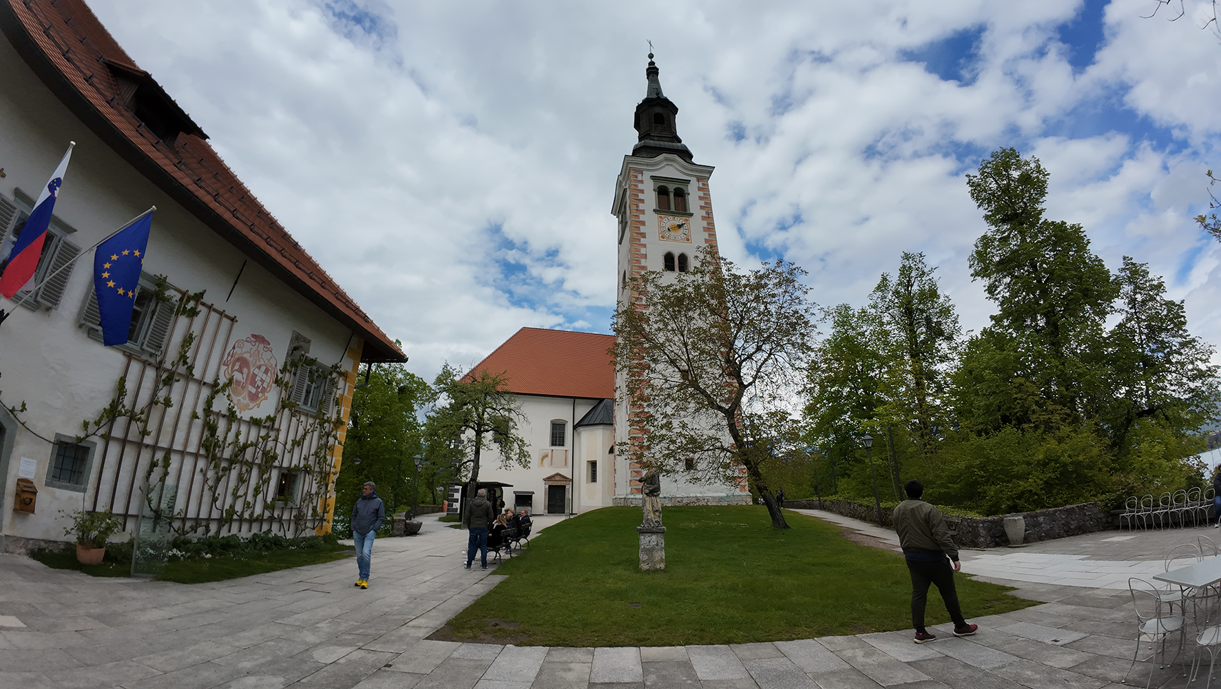 Discover the enchanting Bled Island with the Church of the Assumption in the background, set amidst the serene waters of Lake Bled, offering a picturesque and tranquil Slovenian landmark.