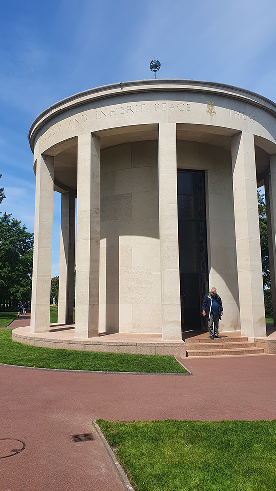 The solemn entrance to the memorial building at Normandy American Cemetery, a tribute to the valor and sacrifice of World War II soldiers.