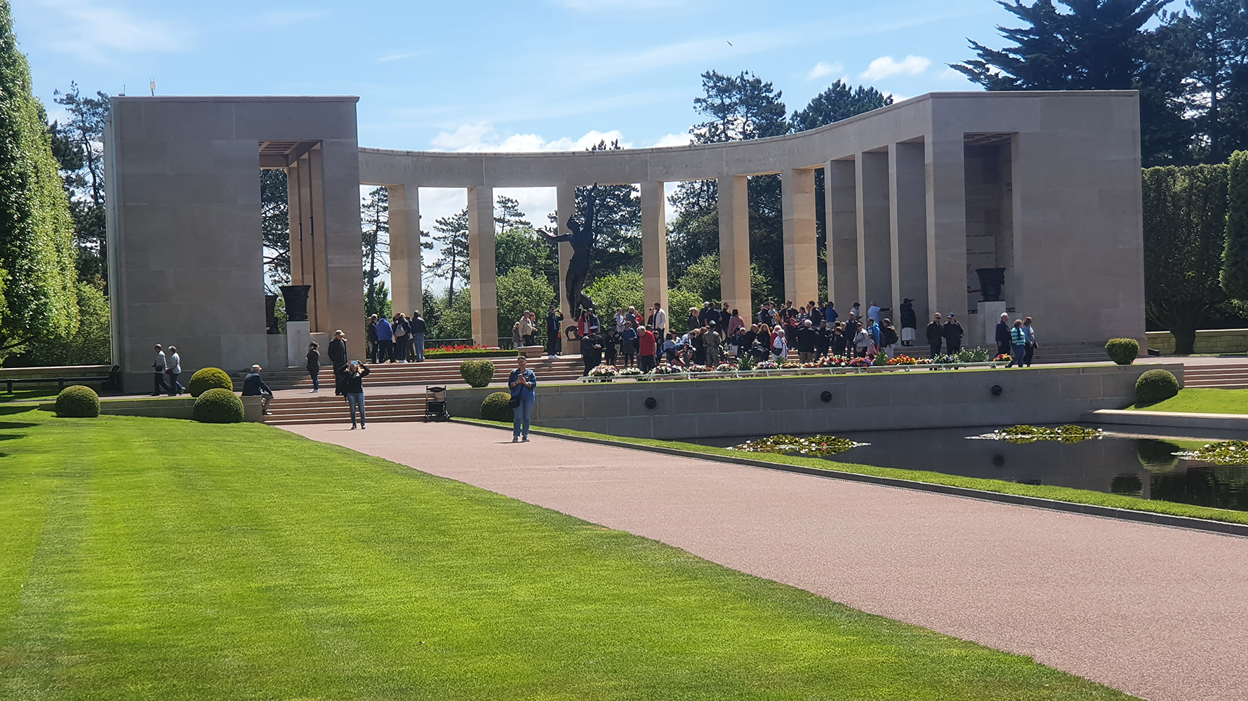 The solemn pillared section of Normandy American Cemetery, a timeless tribute to the brave soldiers who sacrificed their lives in World War II.