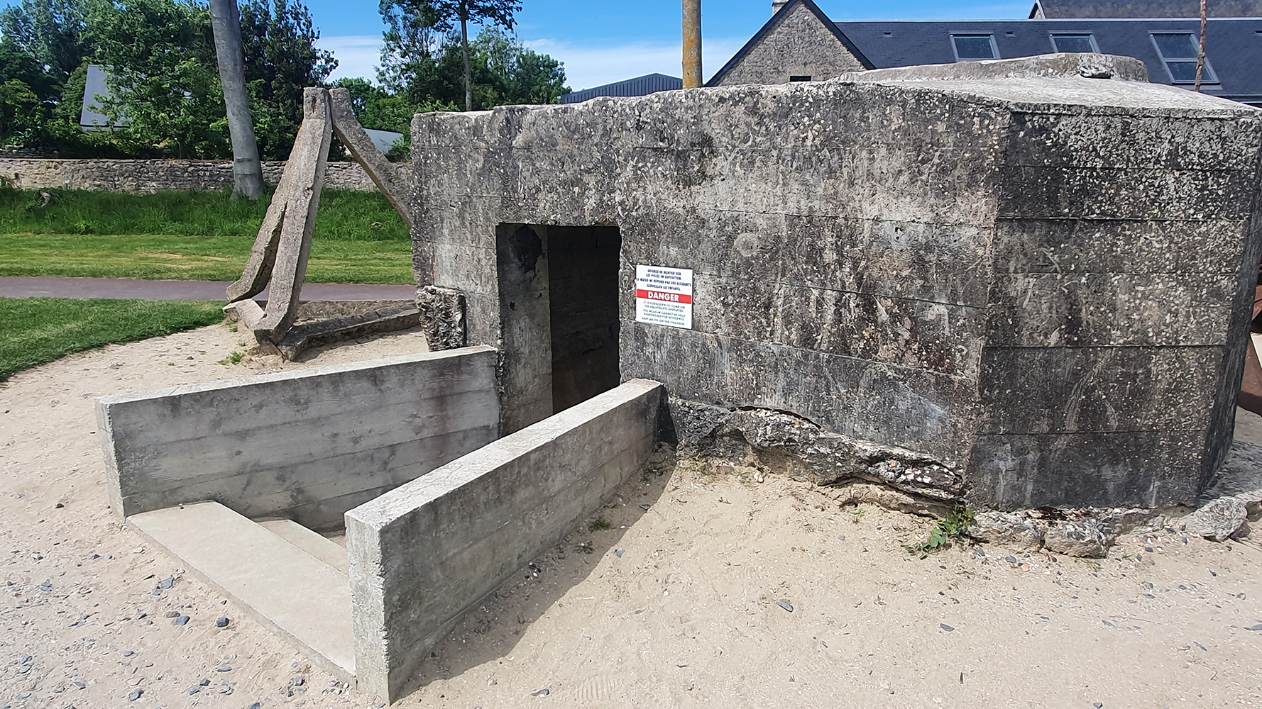 A preserved World War II bunker on display at the Overlord Museum, offering a glimpse into the strategic defenses of the era.