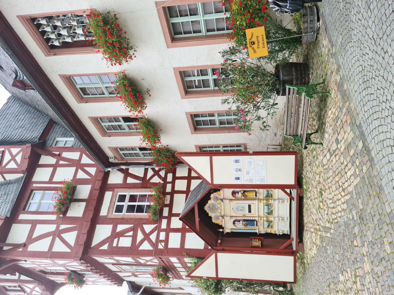 Cobbled streets of Rüdesheim am Rhein town, lined with historic buildings and colorful shops.