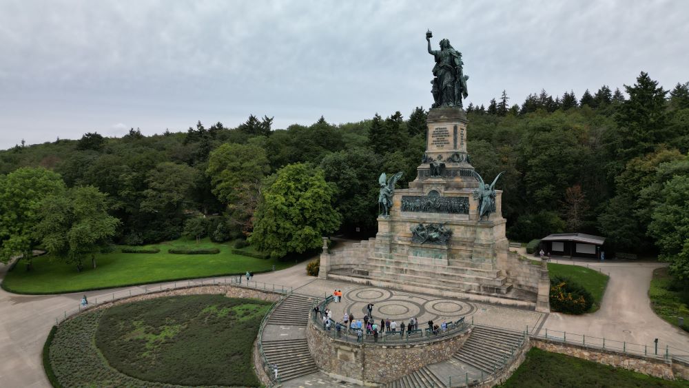 Aerial view of Niederwald Monument, a towering statue overlooking the Rhine River and surrounding landscape.