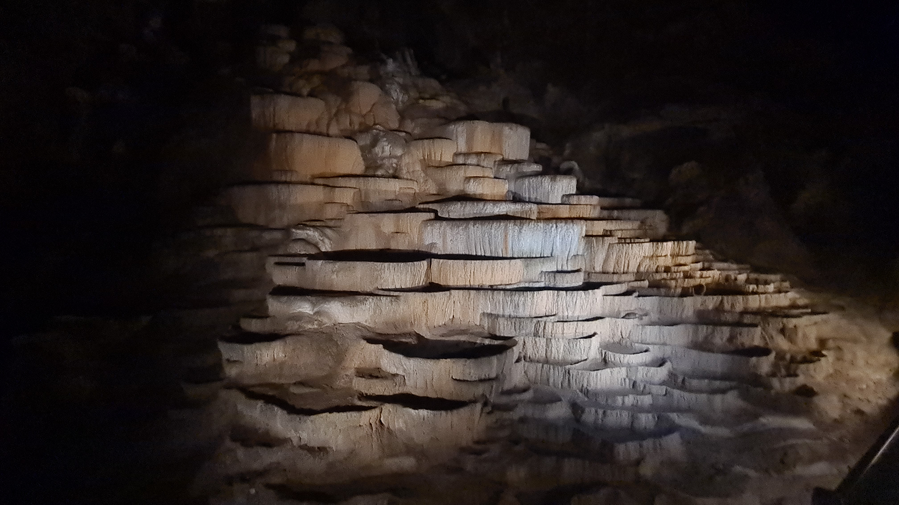 Close-up view of layers of stone formations inside Skocjan Caves, showcasing the geological wonders of the underground world.