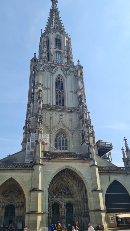 Towering Bern Cathedral with intricate medieval architecture under a clear sky