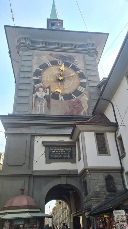 Zytglogge Clock Tower with intricate designs on a building, set against a clear sky