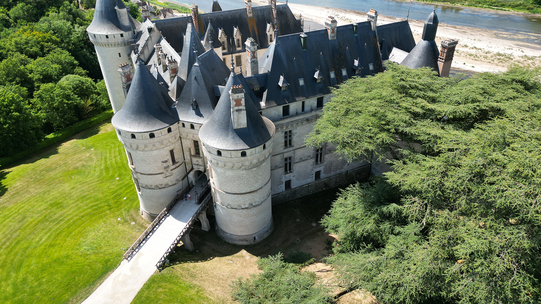 Aerial view of the majestic Château de Chaumont, surrounded by picturesque landscapes and lush greenery.
