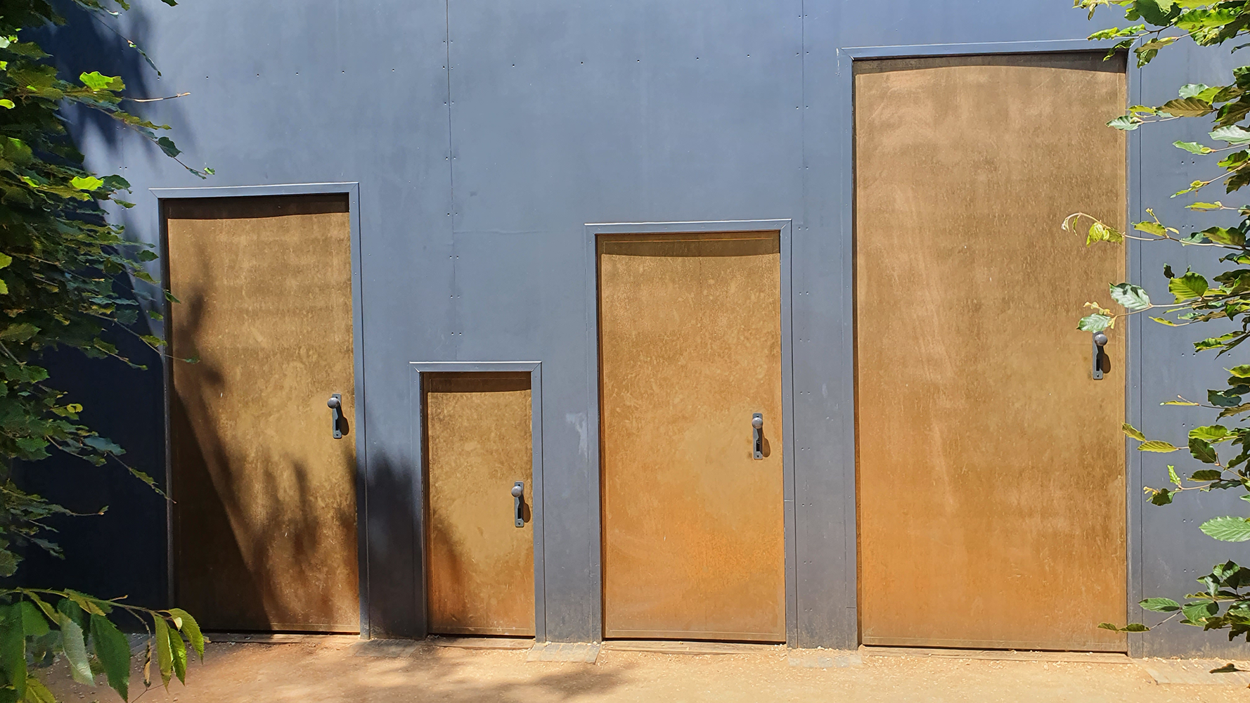 Unique variable-size doors at the Château de Chaumont garden, adding intrigue and charm to the landscape.