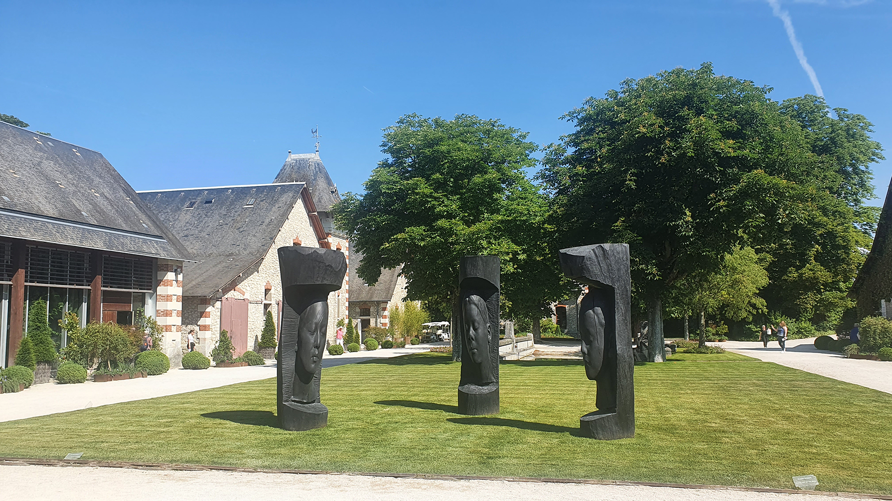 A striking stone pillar sculpture in the Château de Chaumont garden, adding an element of elegance to the landscape.